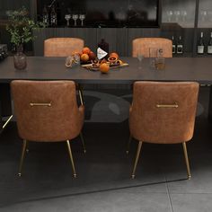 a dining room table with four chairs and bottles on the wall behind it in front of a television