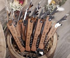 a bunch of knives that are sitting in a wooden container with flowers on the side