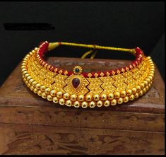 Vajratik jewellery is a traditional jewellery that is made by closely placing golden balls filled with wax to form sturdy jewellery. It has become famous all over India because of its lightweight and budget-friendly price point. This beautiful ornament is completely handmade which reflect Marathi karagiri. The necklace has adjustable thread attached. Vajratik Necklace, Adjustable Gold Kundan Necklace In Temple Jewelry Style, Traditional Adjustable Gold Kundan Necklace, Traditional Gold Bridal Necklace Adjustable, Traditional Adjustable Gold Bridal Necklace, Adjustable Gold Bridal Necklace For Festivals, Heavy Gold Necklaces With Round Beads, Gold Meenakari Bridal Necklace With Round Beads, Adjustable Gold Temple Necklace For Festive Occasions