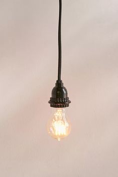 an old fashioned light bulb hanging from a ceiling