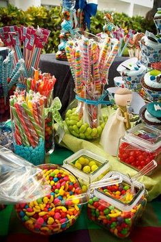 a table filled with lots of candy and candies on top of it's sides