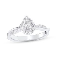 a white gold engagement ring with diamonds on the band and a pear shaped diamond in the center