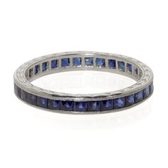 a white gold ring with blue sapphire stones