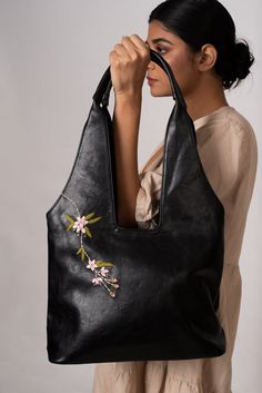 Designed to be light weight, the tote is a winner when it comes to utility, style and comfort. The inside is lined with suede and well structured with two open pockets and a zipped pocket to keep your valuables organized. Pink Lilies, Utility Style, Vegan Leather Tote, Pink Lily, Style Expert, Leather Design, Leather Tote, Hand Embroidered, Vegan Leather