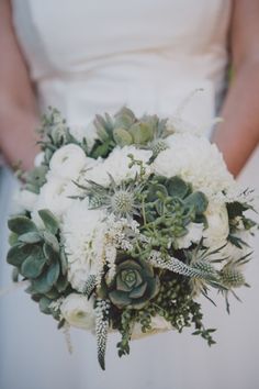 the bride's bouquet is made up of white flowers and succulents