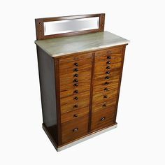 an old wooden dresser with mirror on it's top and bottom drawer, against a white background