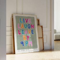 an art work is displayed on the floor next to a framed poster that says live laugh leave by 9pm