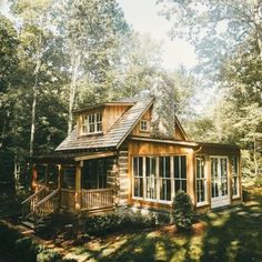 a small wooden cabin in the woods surrounded by trees