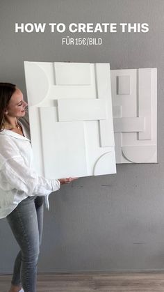 a woman holding up a large white piece of art with the words how to create this