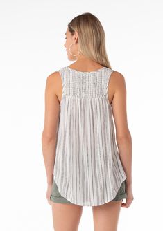 A casual spring tank top in a black stripe. Striped Relaxed fit Sleeveless Round hemline V-neckline Smocked yoke detail Bohemian resort tank top Sweet and simple, our effortless tank top features a classic striped detail. With a flattering v-neckline and smocked yoke detail. The perfect throw-on-and-go style for all season long. Model is 5'9, wearing a size S.Style: I-13824W-SAJ-MP Striped V-neck Tank Top, Striped V-neck Tank Top For Spring, Casual Smocked Back Tank Top For Vacation, Casual Tank Top With Smocked Back For Day Out, Casual Sleeveless Camisole With Smocked Back, Summer Sleeveless Striped Top, Chic Vacation Tank Top With Smocked Back, Striped Sleeveless Summer Top, Chic Tank Top With Smocked Back For Vacation