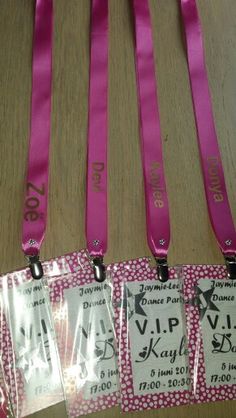 four pink lanyards with tags attached to them