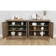 two wooden shelves with dishes and cups on them