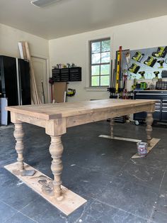 a large wooden table sitting inside of a garage