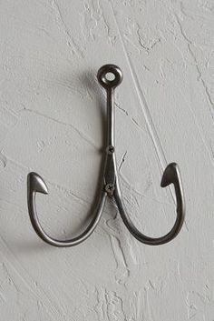 a metal hook on the wall holding an umbrella