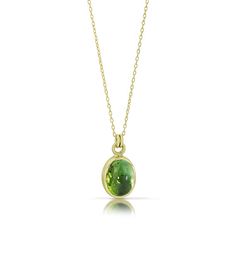 This piece just glows! The green tourmaline is wrapped in a 14K green gold bezel and the pairing of stone and metal is divine. This pendant, with its verdant color, is one of our favorites. Our signature Cashmere Finish® gives a softness to the metal and makes the stone sing. More like this: Tourmaline Cabochon Rings PRODUCT SPECIFICATIONS: Stone is 3.66ct and approximately 10x8mm Chain is 18" long Tourmaline Jewelry Round, Luxury Spiritual Tourmaline Necklaces, Green Round Stone Necklace, Luxury Green Domed Jewelry, Luxury Green Necklace With Round Stone, Luxury Green Round Stone Necklace, Cheap Green Stone Jewelry, Luxury Green Pendant Jewelry, Luxury Green Stone Setting Necklaces