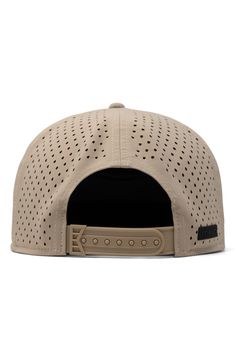 a beige hat with holes on the front and side panel, showing the visor