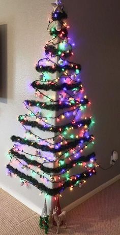 a christmas tree is decorated with multicolored lights