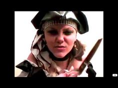 a woman dressed as a pirate holding a knife