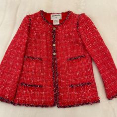 Gorgeous Red Tweed Jacket With Purple Trim And Gold Buttons On Front, Back, And Cuffs. Red Silk Camellia Lining. Very Good Condition! Authenticity Guaranteed. Rare Spring 2006 Collection. Measurements: Fr 34 Shoulder 16” Chest 34” Length 22” Red Tweed Jacket, Chanel Jackets, Chanel Tweed Jacket, Purple Trim, Chanel Tweed, Chanel Jacket, Red Silk, Gold Buttons, Tweed Jacket