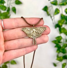 Embrace the magic of the night with this handcrafted brass luna moth pendant. Intricately designed to capture the ethereal beauty of the luna moth, it adds a touch of nocturnal enchantment to any outfit. Perfect for lovers of the mystical and whimsical! 🌙🦋 Diameters: 1.56 x 1.1 Necklace cord - 18 inch Gold Butterfly Jewelry For Festival, Handmade Spiritual Butterfly Necklace, Bohemian Butterfly Necklace Gift, Bohemian Butterfly Necklace For Gift, Gold Bohemian Butterfly Necklace, Handmade Bohemian Butterfly Necklace, Handmade Adjustable Bohemian Butterfly Necklace, Handmade Gold Bohemian Butterfly Necklace, Moth Pendant