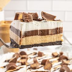 a piece of cake is being lifted from the pan by a fork with chocolate and marshmallows on it