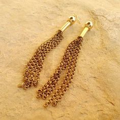 These gold tassel earrings created by Jewelry by CARMAL are made of gold filled: chain, beads earring hooks and findings. These earrings measure 4 inches in length. See more dangle earrings: http://www.etsy.com/shop/jewelrybycarmal?section_id=8002052 All of our jewelry comes wrapped and ready for gift giving! We also offer free standard shipping within the United States. We accept custom orders and would love to work with you! Please see other items in our shop: http://www.jewelrybycarmal.etsy.c Gold Metal Jewelry With Tassels, Gold Metal Tassel Jewelry, Elegant Gold Tassel Earrings With Ear Wire, 14k Gold Filled Chain Dangle Earrings, Brass Chain Earrings For Gift, Gift Chain Earrings In Brass, Brass Chain Dangle Earrings, Gold Metal Tassel Earrings As Gift, Gold Metal Tassel Earrings For Gift