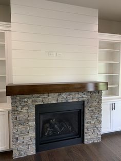 a fireplace with built in bookshelves next to it