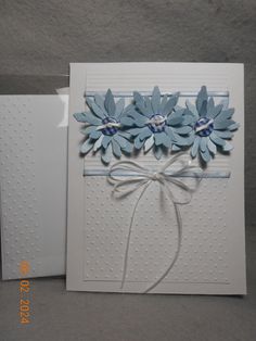 a white card with blue flowers on it