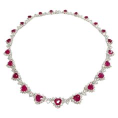 Prepare to make a statement with this breathtaking IGI certified 26.58ct Ruby & 17.85ct Natural Diamonds Necklace in 18K White Gold. Crafted with exquisite artistry and attention to detail, this extraordinary piece is a true masterpiece that showcases the mesmerizing beauty of rubies and diamonds. The focal point of this necklace is the 23 heart-shaped natural rubies, totaling 26.58 carats, each exuding a deep red hue that is synonymous with the finest Burmese rubies. Certified by IGI to ensure their origin from Burma, these rubies are renowned for their exceptional quality and lustrous color, making them a rare and coveted gemstone in the world of jewelry. Complementing the rubies are a total of 414 round brilliant diamonds, weighing 17.85 carats, meticulously set in heart-shaped patterns Luxury Bollywood Ruby Necklaces, Rubies And Diamonds, Ruby And Diamond Necklace, Burmese Ruby, Diamonds Necklace, Mesmerizing Beauty, Color Making, Ruby Necklace, Ruby Diamond