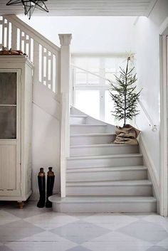 an image of a room with stairs and a christmas tree on the top of it