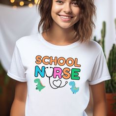 Cute School Nurse Tshirt: Discover cozy and stylish tees celebrating school nurses! Perfect for honoring their dedication or gifting to your favorite healthcare hero. Made from our BELLA AND CANVAS brand, this tee offers style and comfort. Here's what you need to know before you make your purchase: 1.Unisex Adult Sized Shirts. They're not women's fitted shirts, so for a more fitted look, consider sizing down. 2.Rolled Sleeves in pictures are for styling purposes only. 3.Props used in photos are NOT included with purchase. PRINT DESIGN 1.This is a Direct-To-Garment printed item, ensuring durability without cracking or peeling. 2.The ink is printed INTO the fabric, ensuring longevity. WASHING INSTRUCTIONS 1.Wash inside out, in cold water, on a gentle cycle. Tumble dry low or let air dry. 2.D College T-shirt With Funny Text And Short Sleeves, Funny Text Crew Neck T-shirt For College, Funny College T-shirt With Letter Print, Funny Letter Print T-shirt, College Fun School Spirit T-shirt With Funny Text, Cute Slogan T-shirt For Back To School, Funny Pre-shrunk College T-shirt, Funny Text Print T-shirt For School, Teacher Appreciation Crew Neck T-shirt For Back To School