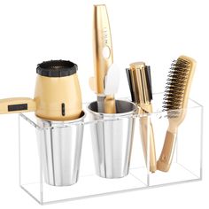 a hairdryer, brush, and other items are arranged in a clear holder