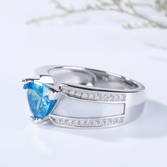 Unique but beautiful, this ring features its trillion-cut aquamarine blue center stone and the special design on the shank. The center stone captivates with brilliance from every angle and the shank shows special charm of the ring. Crafted in 925 sterling silver, decorated with round stone, the ring is of good quality and exquisite craft. If you are looking for unique jewelry for yourself or beloved one, just take this. It won't disappoint you.Carat Weight: 2.15 ctStone Size: 7*7 mmStone Type: Jeulia® StoneNumber of Stones: 1 Stone Color: Aquamarine BlueStone Shape: TrillionCarat Weight: 0.42 ctStone Size: 1 mmStone Type: Jeulia® StoneNumber of Stones: 42 Stone Color: Diamond WhiteStone Shape: RoundWeight: 5 gWidth: 8.1 mmHeight: 6.2 mmThickness: 4.2 mmMaterial: 925 SilverPlating Color: Si Formal Trillion Cut Topaz Ring In Fine Jewelry Style, Formal Trillion Cut Topaz Fine Jewelry Ring, Trillion Cut Birthstone Ring For Formal Events, Formal Trillion-cut Birthstone Ring, Formal Trillion Cut Birthstone Ring, Luxury Blue Opal Ring For Anniversary, Fine Jewelry Trillion Cut Topaz Ring, Fine Jewelry Topaz Ring With Trillion Cut, Fine Jewelry Topaz Ring With Trillion Cut Gemstone