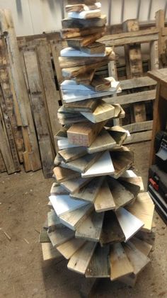 a stack of wooden boards sitting on top of a floor next to a pile of other wood