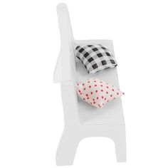 three pillows sitting on top of a white chair