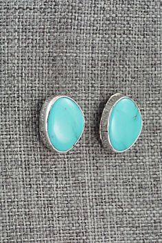 These Sonoran Gem turquoise and sterling silver earrings were made by Navajo silversmith Marco Begaye. The backs are stamped sterling.Length: 5/8"Width: 1/2"Free shipping on all orders! We ship with USPS and always include tracking. All orders ship within a day of payment.Returns are accepted up to 30 days after you receive your order. Just send us a message. Our shop offers cash back or store credit. The item must be returned in new condition. Sterling Silver Turquoise Cabochon Earrings, Bear Carving, Pearl Chain, Native American Jewelry, Turquoise Sterling Silver, Featured Artist, Free Jewelry, White Vintage, Sterling Silver Earrings