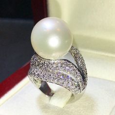 Enormous SOUTH SEA PEARL, absolutely natural color and luster, 14.5 mm in size, surrounded by 257 pieces of hand-set E/VVS superb quality diamonds, weighting at 3.05 carats. Set in handcrafted, one of a kind 18K solid white gold ring, weighting at 13.5 grams. The pearl is naturally cultured from South Australia Sea, its luster is extra fine, AA+ grade with 85% clean surface. SUGGESTED RETAIL PRICE: $13,800 The ring is hand crafted to a high standard and is NOT mass machine produced and is brand Luxury White Diamond Ring For Party, White Diamond Ring For Party In Fine Jewelry Style, White Diamond Ring For Party, Fine Jewelry, White Diamond Ring For Party, White Diamond Party Ring, Elegant Silver Pearl Ring For Party, Elegant White Diamond Ring For Party, Luxury White Diamond Ring With Sparkling Detail, Elegant White Sparkling Rings