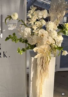 a vase filled with white flowers on top of a table