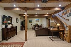 a living room filled with furniture and a stair case