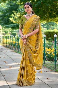 Fancy Silk Saree with blouse in Mustard and Yellow 6215 Get ready for Festive with our stunning Banarasi Silk Sarees. Each saree is a blend of tradition and contemporary fashion, designed to make you shineDesc:  Color : Mustard and Yellow Fabric :  Fancy silk saree Work :  embroidery   Blouse work: raw silk embroidery Wash Care : Dry clean Sleeve Style : Half Sleeve Long Sleeves : Done only in Custom Stitch Sleeves Lining : Done only in Custom Stitch Bust Size : 32 to 42 Inches Occasion : Wedding   Festival   Kitty Party   Sangeet   Party Wear   Engagement   Reception   Ceremonial. With Express Free Shipping and Custom Stitching, Buy Indian Party wedding and bridal Sarees Fancy Silk Saree with blouse in Mustard and Yellow 6215 online in USA, UK and Canada from KollyBoll Raw Silk Embroidery, Engagement Saree, Reception Saree, Raw Silk Saree, Latest Designer Sarees, Yellow Saree, Ghagra Choli, Half Sleeve Blouse, Embroidery Saree