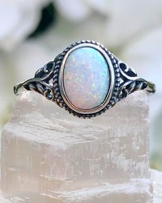 Sterling Silver Oval White Lab Opal Ring | The Life Divine Sterling Silver Oval White Lab Opal RingCherished for its brilliance, Opal is known as a stone of creativity and vitality. Opal is also a reflective stone of protection, absorbing energies and sending them back to their source.Measures approximately 3/8" H x 1/2" W Adjustable Oval Spiritual Rings, Spiritual Oval Crystal Ring With Large Stone, Spiritual Oval Opal Promise Ring, Spiritual Oval Stone Setting Jewelry, White Oval Crystal Ring With Large Stone, Adjustable Oval Opal Ring For Anniversary, White Oval Opal Crystal Ring, Oval Silver Crystal Ring For Healing, White Oval Stone Setting Jewelry