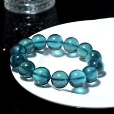 FREE SHIPPING on all items! Experience the exquisite beauty and rarity of our Natural Brazilian Old Mine Devil Blue and Green Aquamarine Round Bead Bracelet. This stunning piece, known for its exceptional quality and vibrant hues, is a true collector's item. Product Details: Material: Genuine Aquamarine Colors: Devil Blue and Green Bead Shape: Round Grade: Collector's Grade Bracelet Type: Stretchable Bead Bracelet Features: Unique Color: The captivating devil blue and green hues are highly sought after and rare, making this bracelet a unique addition to any jewelry collection. High Quality: Sourced from old mines in Brazil, these beads are of the finest quality, ensuring durability and long-lasting beauty. Versatile Design: The round bead design and stretchable band make this bracelet comf Green Aquamarine, Rare Jewelry, Aquamarine Colour, Green Hues, Green Bead, Bead Designs, Rarity, Accessories Unique, Bead Bracelet