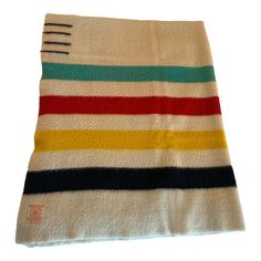 a multicolored striped towel with a fork on the side and a white background