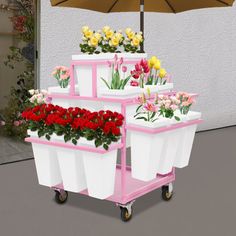 a pink and white cart filled with flowers under an umbrella