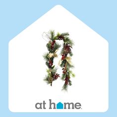 a christmas wreath hanging from the side of a house