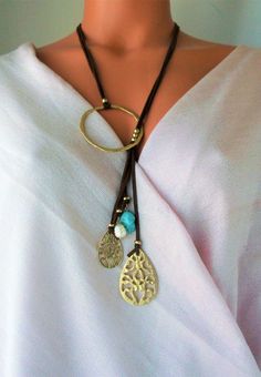 Lovely Leather Lariat necklace. Genuine Turquoises tassel, Unique design NEW vacation Jewelry purchase, never used This is a stunning statement necklace Components include: shiny gold tone quality Brass Genuine 31 inch flat Leather 6 inch Leather Tassel with stone and Brass dangles Handmade in Asia Ready to ship NO waiting Only ONE necklace available Thank you so much for visiting :kaysclassyboutique@etsy.com Handmade Lariat Tassel Necklace, Turquoise Bohemian Tassel Necklace, Bohemian Jewelry With Adjustable Teardrop Chain, Bohemian Lariat Necklace With Tassels, Bohemian Lariat Drop Necklace Gift, Bohemian Long Tassel Necklace With Adjustable Chain, Bohemian Teardrop Jewelry With Adjustable Chain, Bohemian Dangle Long Necklace, Bohemian Long Dangle Necklace