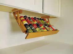 a wooden spice rack with spices and condiments