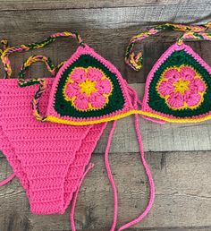 Handmade crochet colorful flower bikini set Triangle Bikini top and Bikini bottom. Washing machine wash  Do not put in dryer Sizes for Bikini Top and Bottom: S - L Bikini Bottom Colors: Pink, yellow, and green. Message me if you have any questions! I am happy to answer! Handmade Pink Swimwear For The Beach, Handmade Pink Swimwear For Vacation, Handmade Fitted Pink Swimwear, Handmade Beachwear Swimwear For Sunbathing, Pink Crochet Swimwear For Vacation, Green Crochet Swimwear For Vacation, Green Crochet Swimwear For Beach Season, Bohemian Crochet Swimwear For Swimming, Handmade Triangle Top Swimwear For Summer