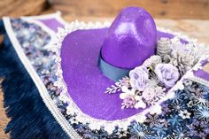 Get your mini trimmed out for some Christmas Cowboy shenanigans!  An amethyst purple colored cowboy hat is trimmed-out with snow dappled foliage and sparkly pinecones. The shawl is made from snowflake patterned calico and edged with smart trim and fringe. The tail piece features a matching calico pattern and finished with festive ribbons. The hat and tail piece attach easily with alligator clips. All our costumes are handmade with heart in the 'holler. If you are ordering outside the US we charg Handmade Purple Party Hat, Adjustable Western Purple Hat, Adjustable Purple Mini Hats For Gifts, Adjustable Purple Mini Hat As A Gift, Handmade Purple Mini Hats With Curved Brim, Handmade Purple Hat For Gift, Handmade Purple Hat As Gift, Western Gothic, Christmas Cowboy