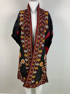 This coat is a testament to the beauty and artistry of handmade clothing, with each stitch telling a story of craftsmanship and attention to detail. It's a perfect investment for anyone who appreciates quality, tradition, and style and is a unique addition to any wardrobe. Note: Worn and minor signs of wear. Traditional Black Shawl Outerwear, Bohemian Outerwear With Embroidered Kimono Sleeves, Traditional Black Kimono For Fall, Vintage Outerwear With Kimono Sleeves For Winter, Embroidered Cape Outerwear For Fall, Multicolor Outerwear With Woven Motifs For Fall, Vintage Winter Outerwear With Kimono Sleeves, Traditional Black Fall Kimono, One Size Shawl Outerwear For Festivals